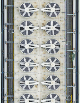 Aerial view of industrial cooling fans and ventilation systems on a factory roof with metal pipes and structural details Hsinchu, Hsinchu City, Taiwan.