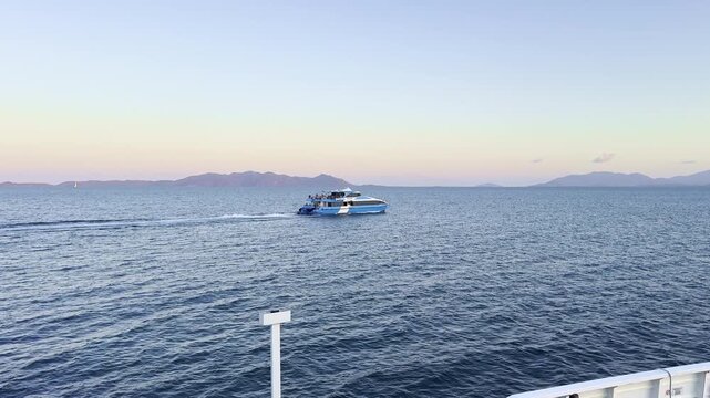 Vehicle and passenger ferry departing from Nelly Bay Harbour on Magnetic Island to Townsville, Queensland, Australia. Coastal transport, travel and maritime connection.