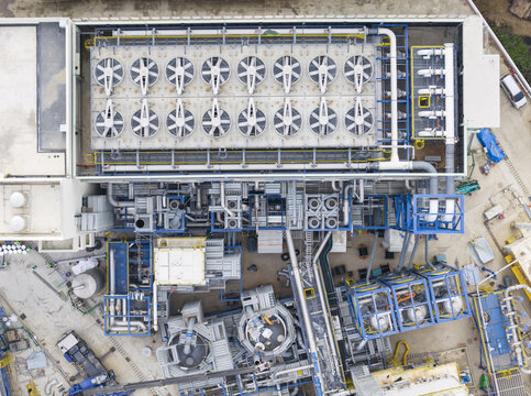Aerial view of an industrial cooling system with large ventilation fans and a complex network of pipes at a manufacturing facility in Hsinchu, Hsinchu City, Taiwan.
