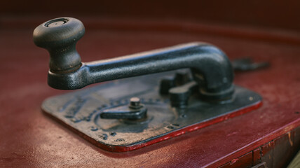 Antique Morse code telegraph key with a wooden knob and metal base © shine.graphics