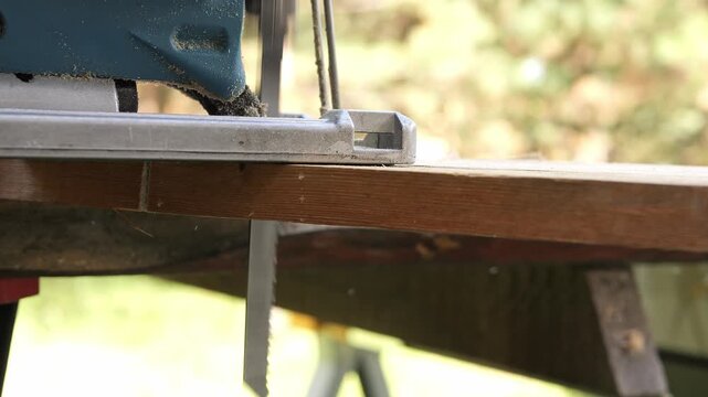 Professional carpenter using power tool in woodworking industry tool operation in workshop tool for cutting wood and construction materials carpenter work with tool in carpentry production process
