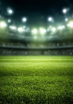 A vast football stadium glows under bright lights at night, showcasing a pristine green pitch.