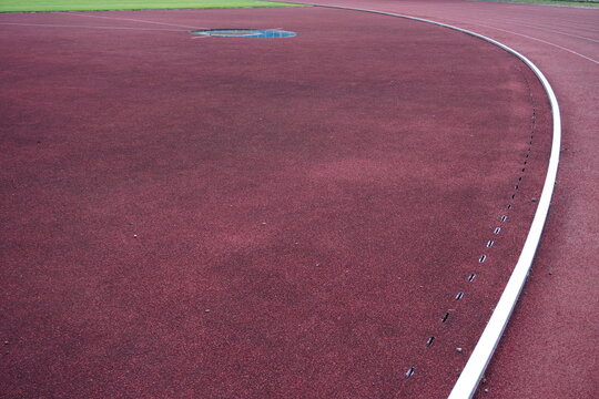 Running track curve with a shot put circle on a stadium field