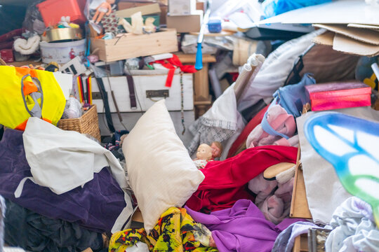 cluttered room with piles clothes and objects, chaotic interior, hoarding disorder concept, mess and overload, domestic space hoarding behavior and accumulation, lack organization mental overload
