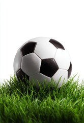 Fototapeta premium A black and white soccer ball rests on vibrant green grass, symbolizing the upcoming World Cup 2026.