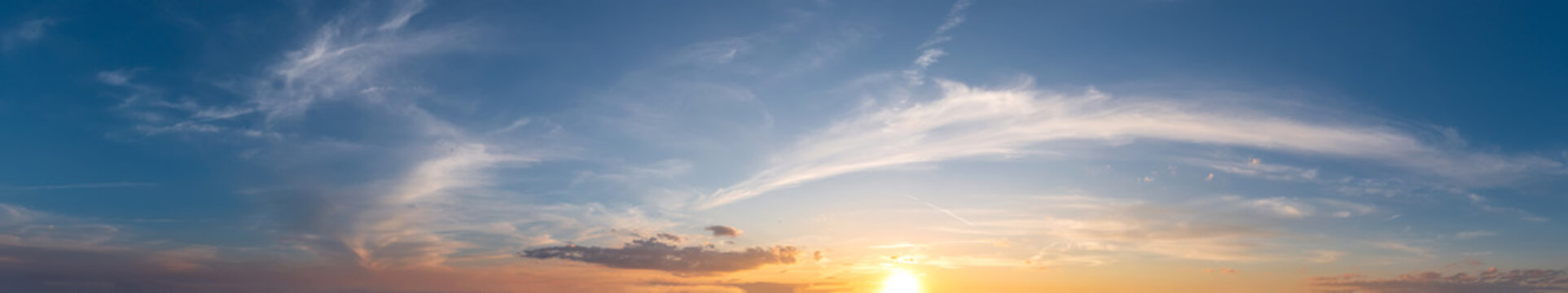Majestic Panoramic Sunset Sky with Wispy Cirrus Clouds over a Golden Horizon
