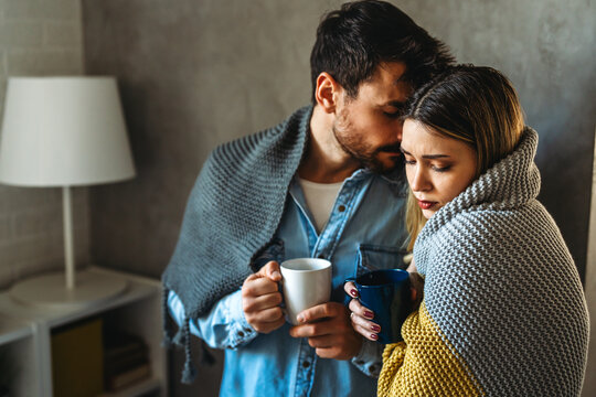 A loving couple shares a quiet winter morning wrapped in warm blankets, finding emotional intimacy