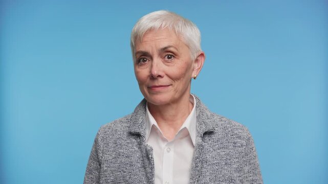 Senior woman shrugging with uncertain expression