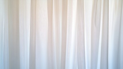 Obraz premium Vertical folds of translucent white curtains illuminated by bright light from behind
