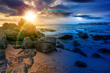 sandy beach landscape. day meet night. sun and moon over beautiful coastal seascape scenery. astrology background for autumn equinox vacation at the shore of black sea with rocks