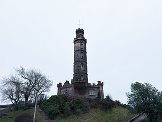 Obraz premium Nelson Monument tower on Calton Hill overlooking Edinburgh, Scotland, UK historic stone landmark and panoramic city viewpoint