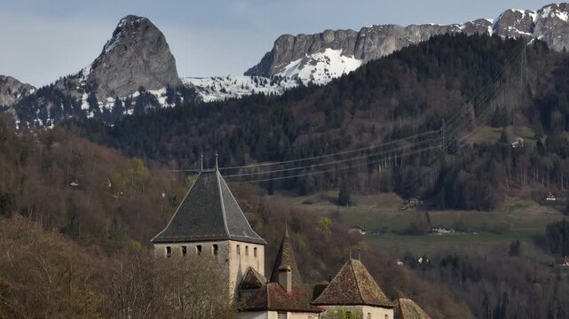 Aerial view of the castle of Blonay, with rochers de naye and dent de Jaman behind, Vaud, Switzerland	