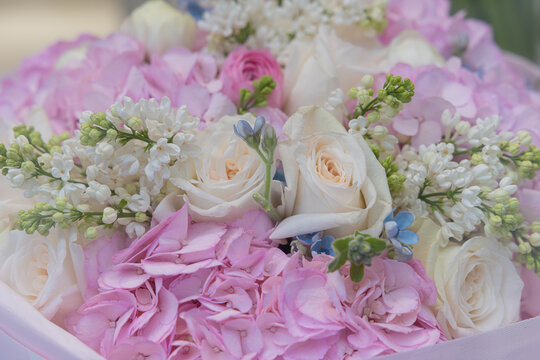 Pastel flower bouquet with white roses, pink hydrangea, and lilac