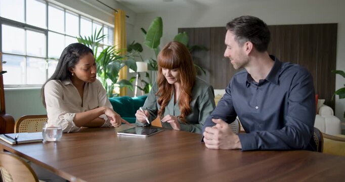 Financial advisor meeting with a couple to discuss finances