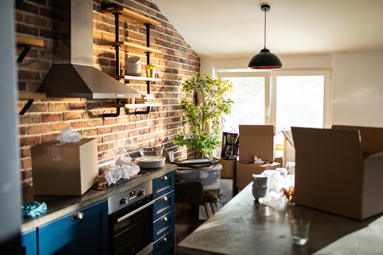 Modern brick apartment kitchen with moving boxes