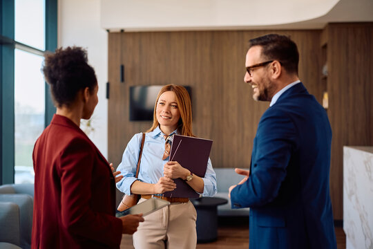 Happy businesswoman talking to corporate managers while applying for office job.