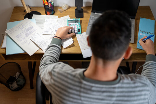 Entrepreneur calculating business finances amidst economic crisis