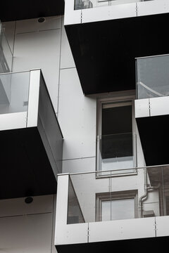 Modern urban architecture features a geometric building with balconies where pattern and lines define design in high contrast monochrome style