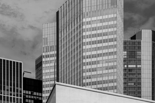 Modern office glass skyscraper shapes the Frankfurt skyline as architecture defines a city urban profile captured in crisp monochrome light