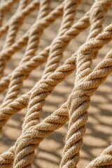 Fototapeta premium Close up of thick natural rope net texture with knots and fibers marine nautical background