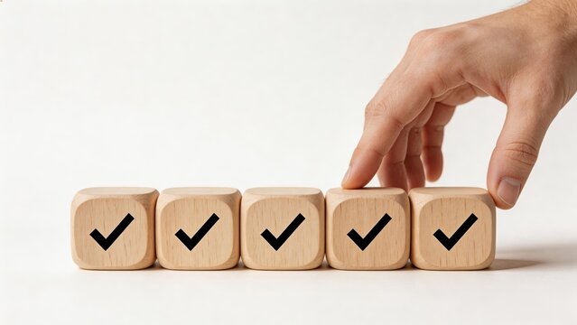 Business man hand placing wooden cube with check mark symbol on white success concept