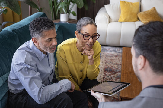 Senior couple looking at an investment plan with financial advisor
