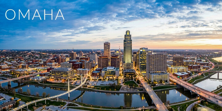 Beautiful Omaha skyline and Bob Kerrey Pedestrian Bridge spanning the Missouri River during a vibrant sunset