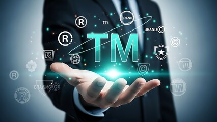 Fototapeta premium Businessman holding trademark symbols and brand protection in hand