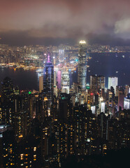 Fototapeta premium Hong Kong night evening view, China, seen from Victoria Peak observation deck, Lugard road lookout, with Hong Kong downtown skyscrapers and Kowloon island, illuminated city and Victoria Bay at night