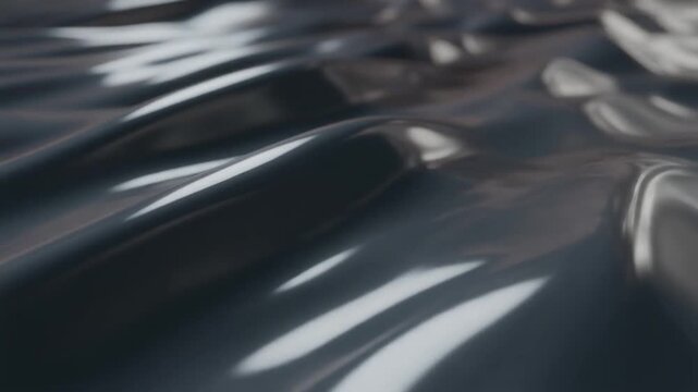 Abstract dark liquid surface with reflective highlights, creating a fluid and dynamic visual texture