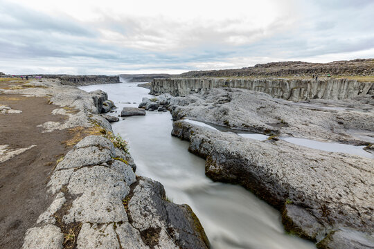 River running through a rocky canyon with a sky background, Selfoss, Iceland, long exposure motion blur