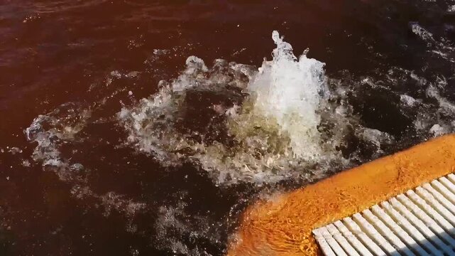 Close up view of a powerful hydrotherapy jet bubbling vigorously in a pool. The turbulent water creates a relaxing massage effect in Demanovska Dolina, Slovakia