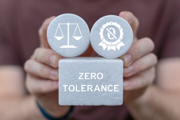 Zero tolerance concept. Person holding white blocks with icons sees the inscription ZERO TOLERANCE.