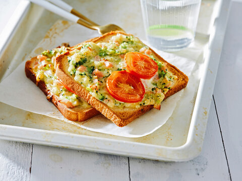 The image shows toasted bread topped with melted cheese and fresh tomatoes. This dish is ideal for quick snacks, casual dining, or simple meal solutions in restaurants and cafes