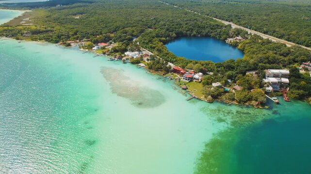 Aerial view of Bacalar lagoon and Cenote Azul with contrasting blue water shades