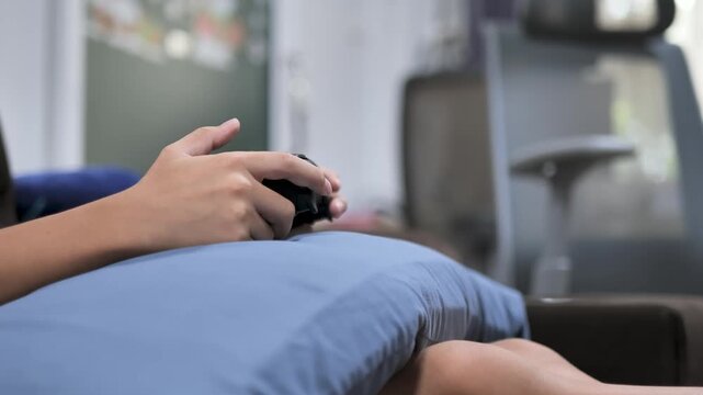 Close-up of a 10 year old child using a game controller at home. The image represents gaming, entertainment, and modern digital lifestyle for children.