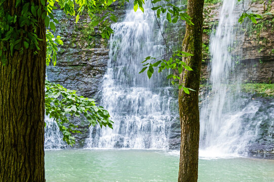 Three broad streams of water flow elegantly down the cliff creating a stunning triple waterfall at Camp Orr in Arkansas. Bokeh.