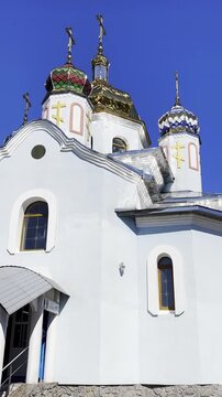 Easter blessing takes place in front of an Orthodox church with traditional baskets and candles creating a sacred festive atmosphere in Onishky Poltava region Ukraine