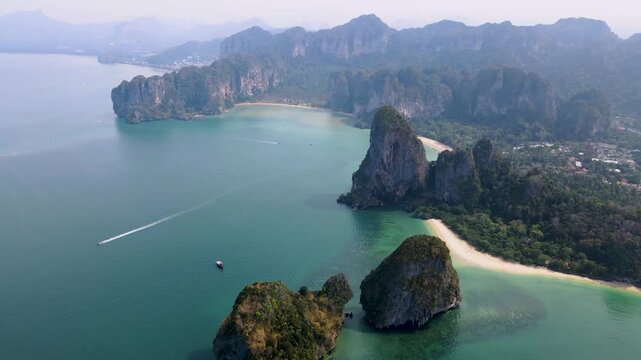 Explore stunning Railay Beach, surrounded by majestic limestone cliffs and crystal-clear waters. This tropical haven is perfect for sunbathing, swimming, and adventure activities. Krabi Thailand