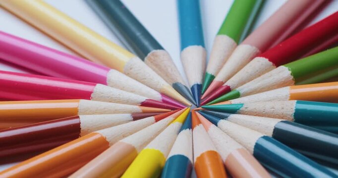 Extreme macro view of sharpened colored pencils arranged in a circle. Rich wooden texture and bright pigment cores, artistic stationery still life for school and creativity projects 4K.