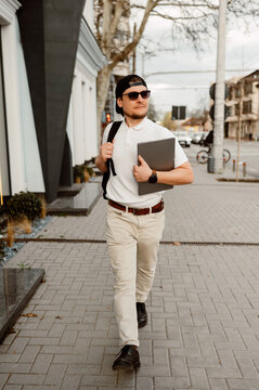 Man Walking With Portfolio And Phone, Confident Stride Through City Street, Sunglasses, Backpack, Neat Outfit,