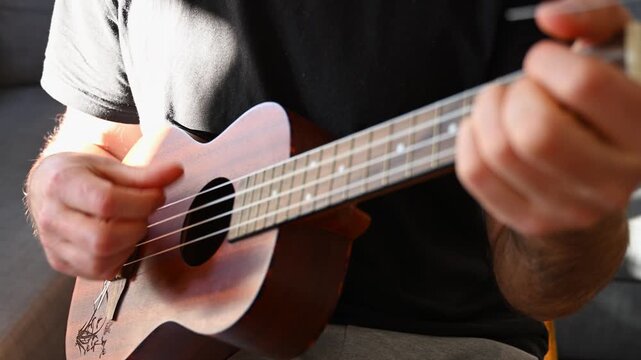 Slow Motion Video of Man Strumming Ukulele Close Up