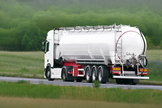 Oil tanker lorry transporting liquid cargo through countryside