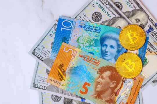 Different types of currency including New Zealand dollars Bitcoin coins on white background