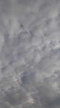 Textured clouds timelapse overcast sky layered stratocumulus rolling across frame, muted gray tones, soft backlight, cinematic slow motion, subtle light pockets