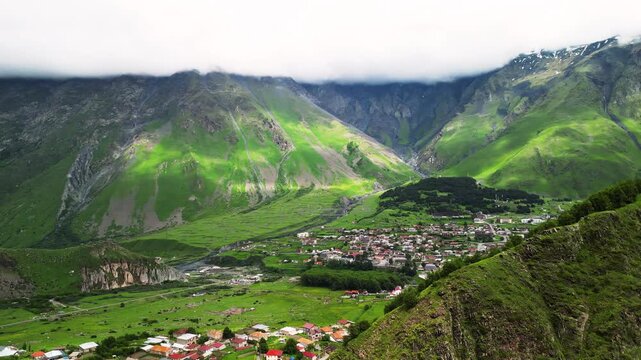 Green mountain hills with grassy slopes scenic alpine valley aerial drone view.
