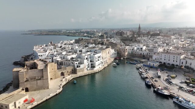 Aerial view of Monopoli old town with harbor, lighthouse and Adriatic coastline, Apulia, southern Italy