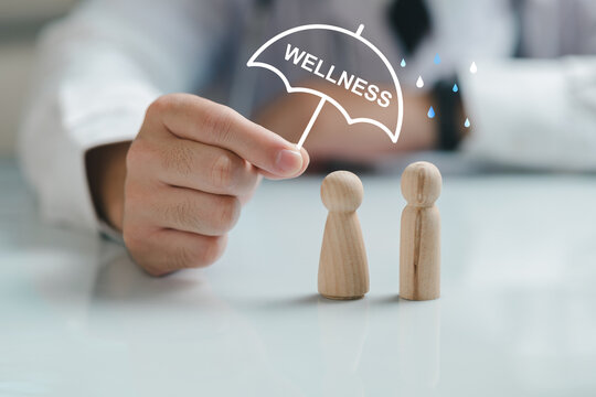 The concept of health insurance and wellness: the doctor's hand holding an umbrella to protect people's health, the concept of health and well-being, insurance, safety, good health, clinics.