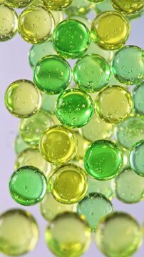 Vibrant Green Hydrogel Beads Translucent Spheres Floating in a Macro Abstract Composition for Wellness Backgrounds or Scientific Concept Videos Vertical. Video. Portrait Orientation.