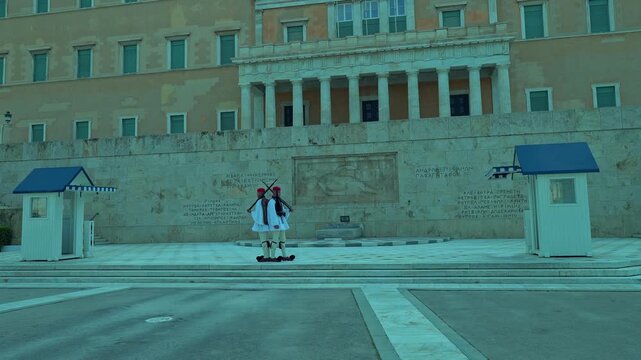 Greek Evzones guards perform a synchronized ceremonial changing of the guard in front of the Hellenic Parliament and Tomb of the Unknown Soldier in Athens.